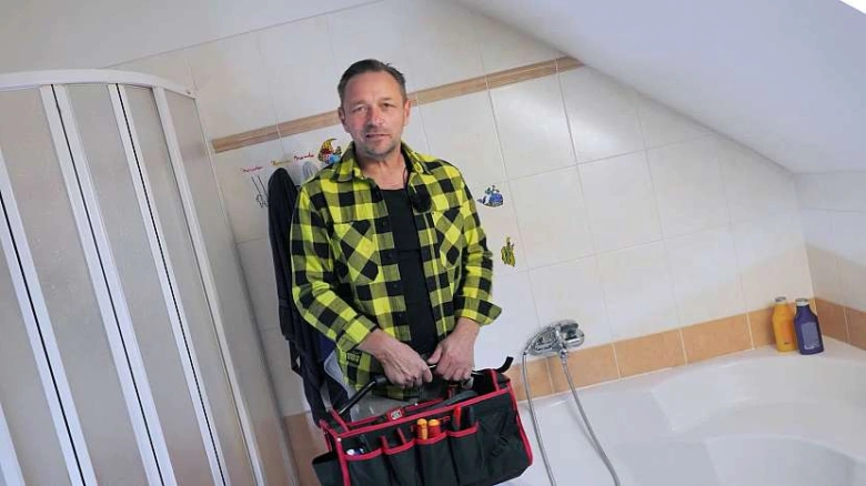 Man with shower tools