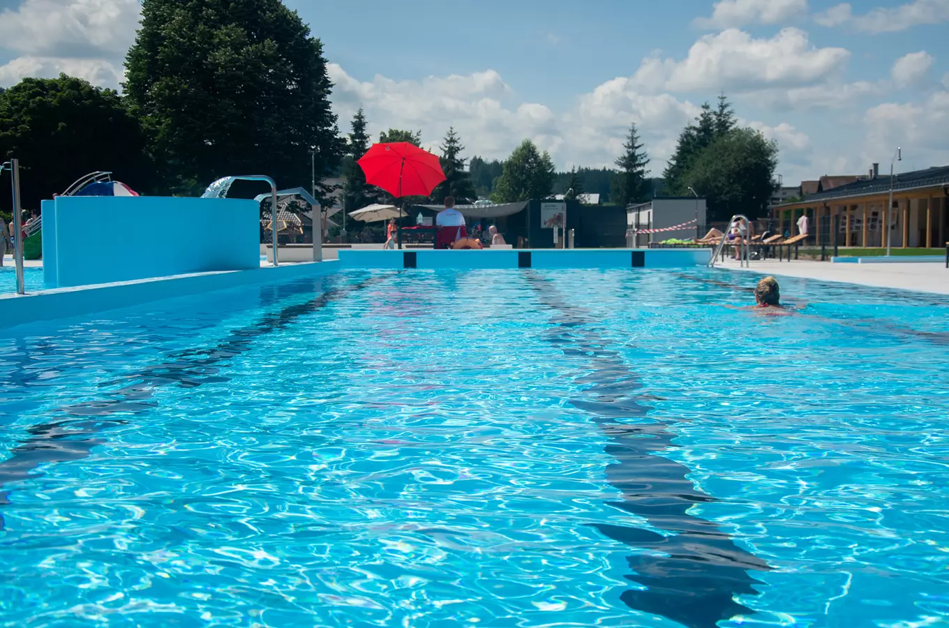 Outdoor swimming pool with swimmer