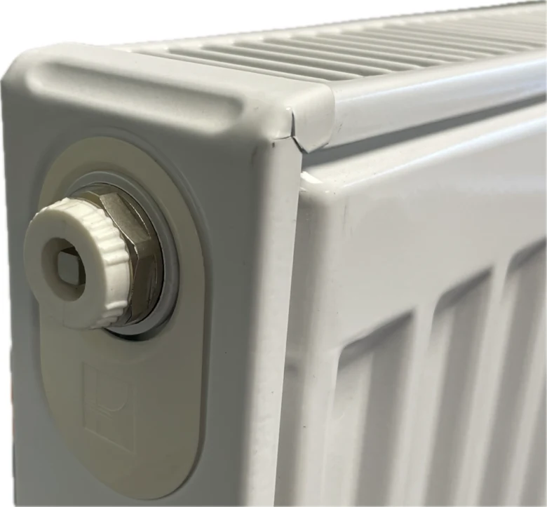 Bílý radiátor s ventilací pro odvzdušnění topení.