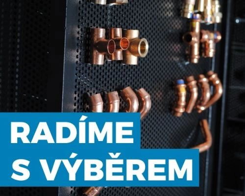 Různé měděné spojky pro odvod dešťové vody na černé desce.