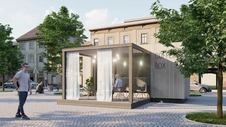 Modulová dřevostavba kavárny v městském prostředí s venkovním posezením.