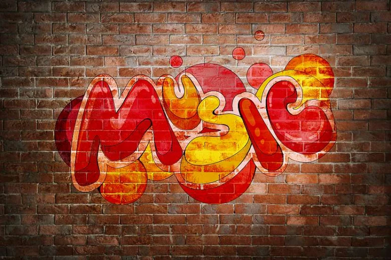Kolorovaný grafiti s nápisem MUSIC na cihlové zdi.