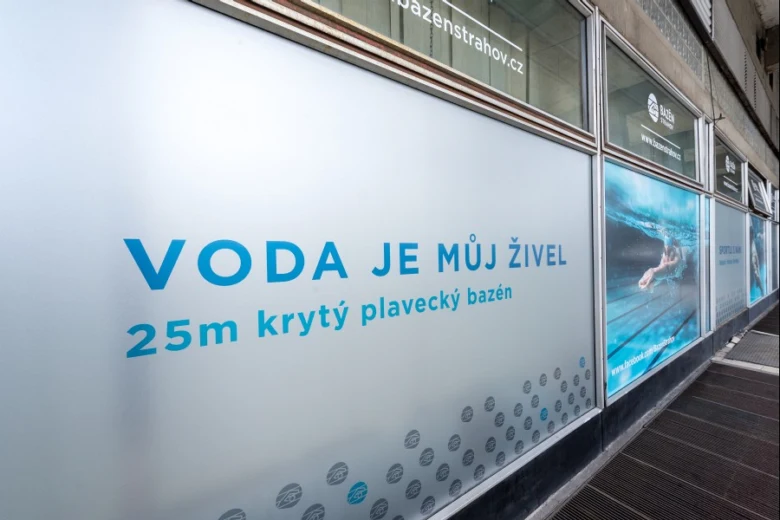 Frosted glass sign showing information about Bazén Strahov.