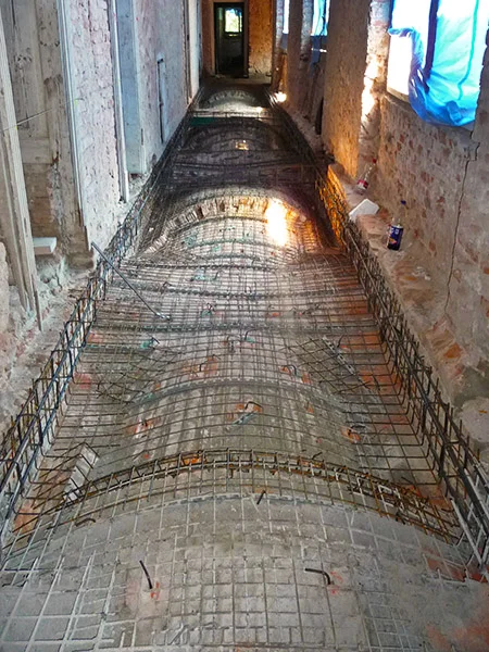 Helikální výztužná síť na podlaze budovy ve stavbě.